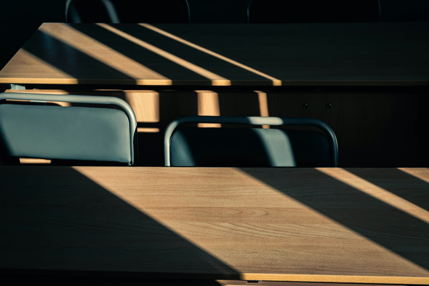 Evening light falling across desks in a quiet studio